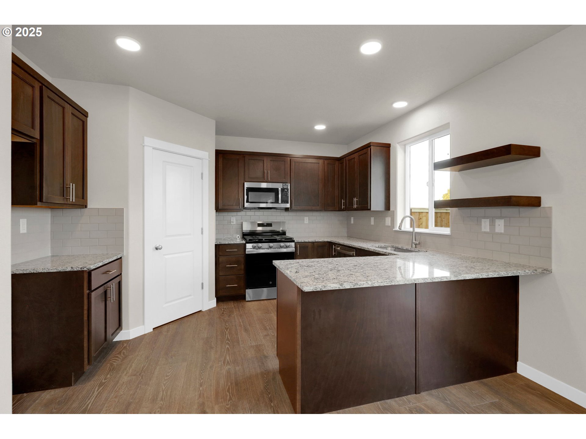 5679 Magnificence Way Eugene, OR 97402 - Photo 24 of 45 a kitchen with stainless steel appliances granite countertop a refrigerator a sink a stove and oven