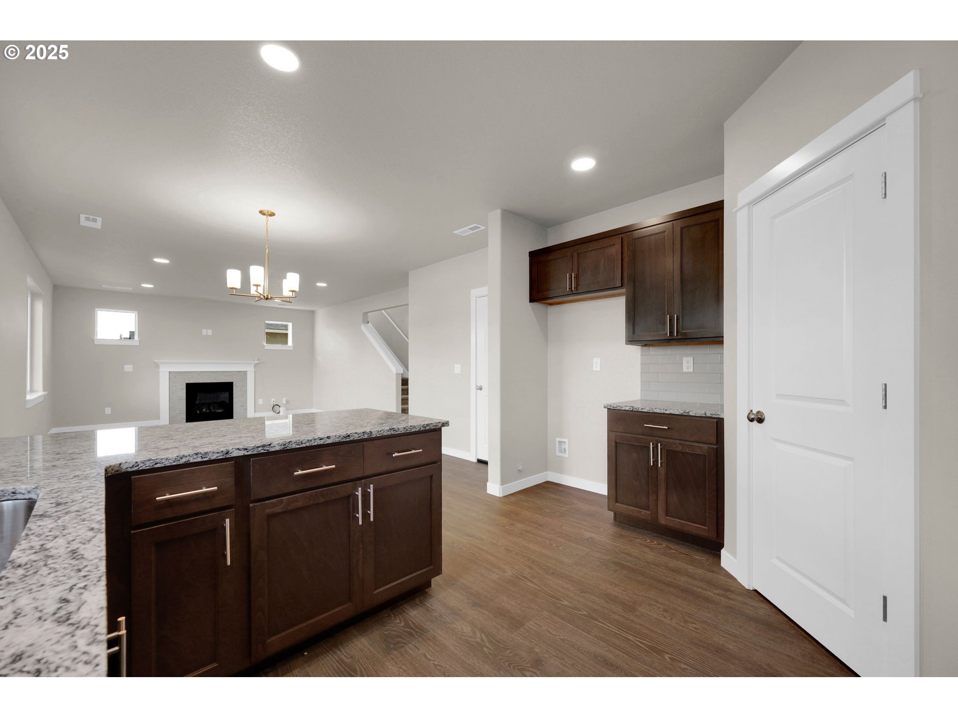 5679 Magnificence Way Eugene, OR 97402 - Photo 26 of 45 a kitchen with a sink and a stove top oven with wooden floor