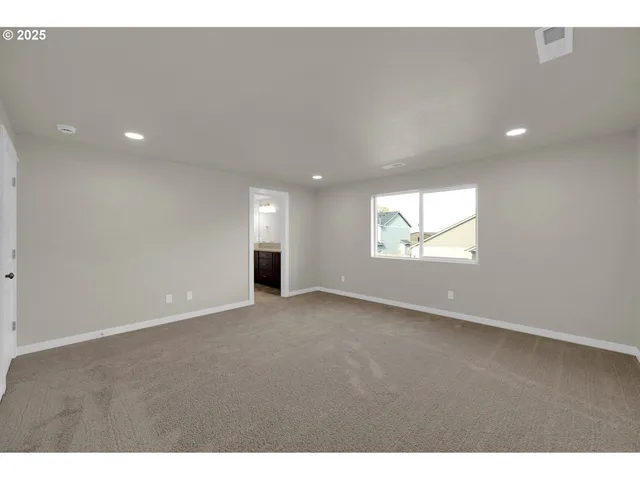 a view of an empty room and a window