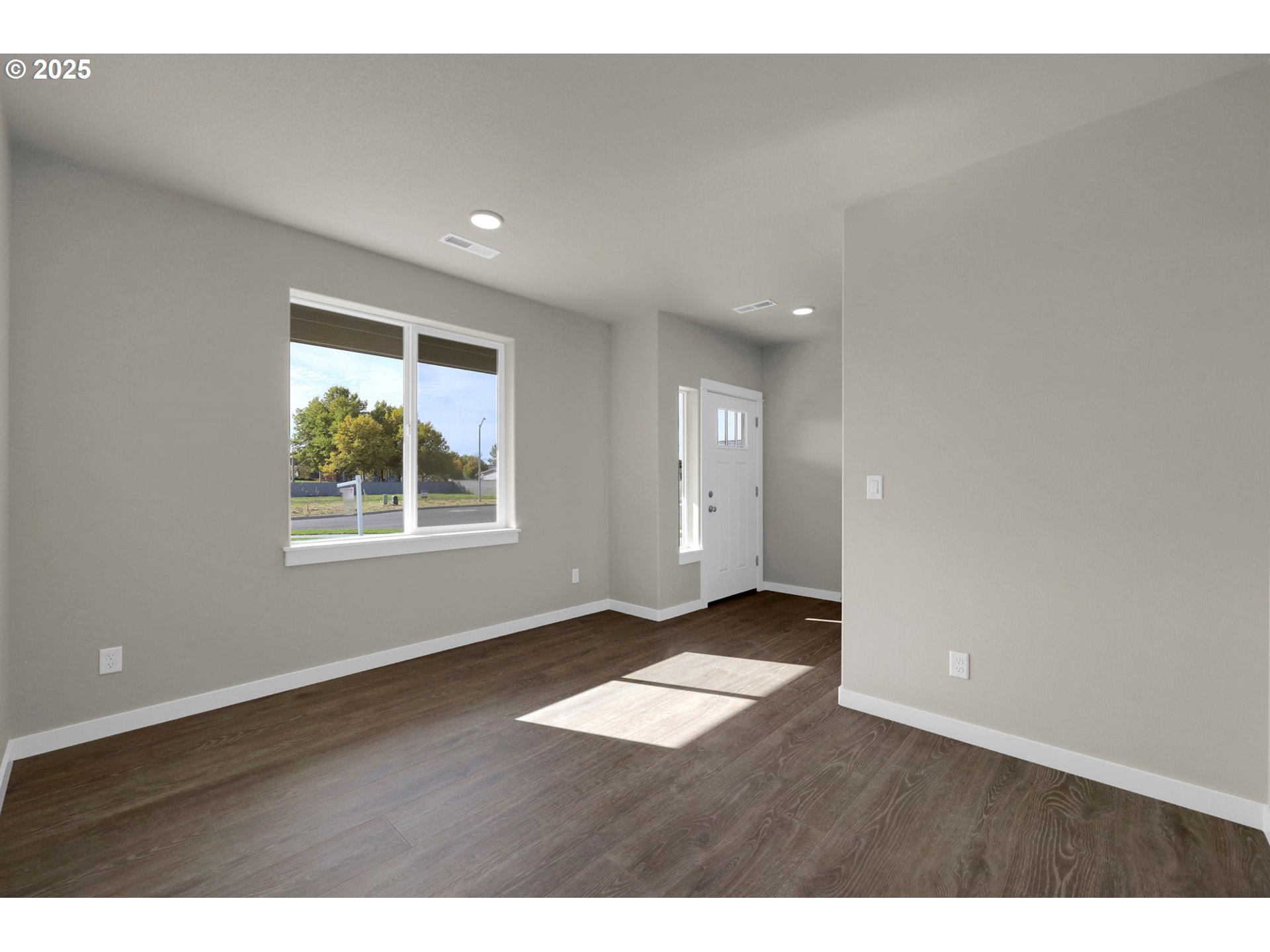 5679 Magnificence Way Eugene, OR 97402 - Photo 5 of 45 an empty room with wooden floor and windows