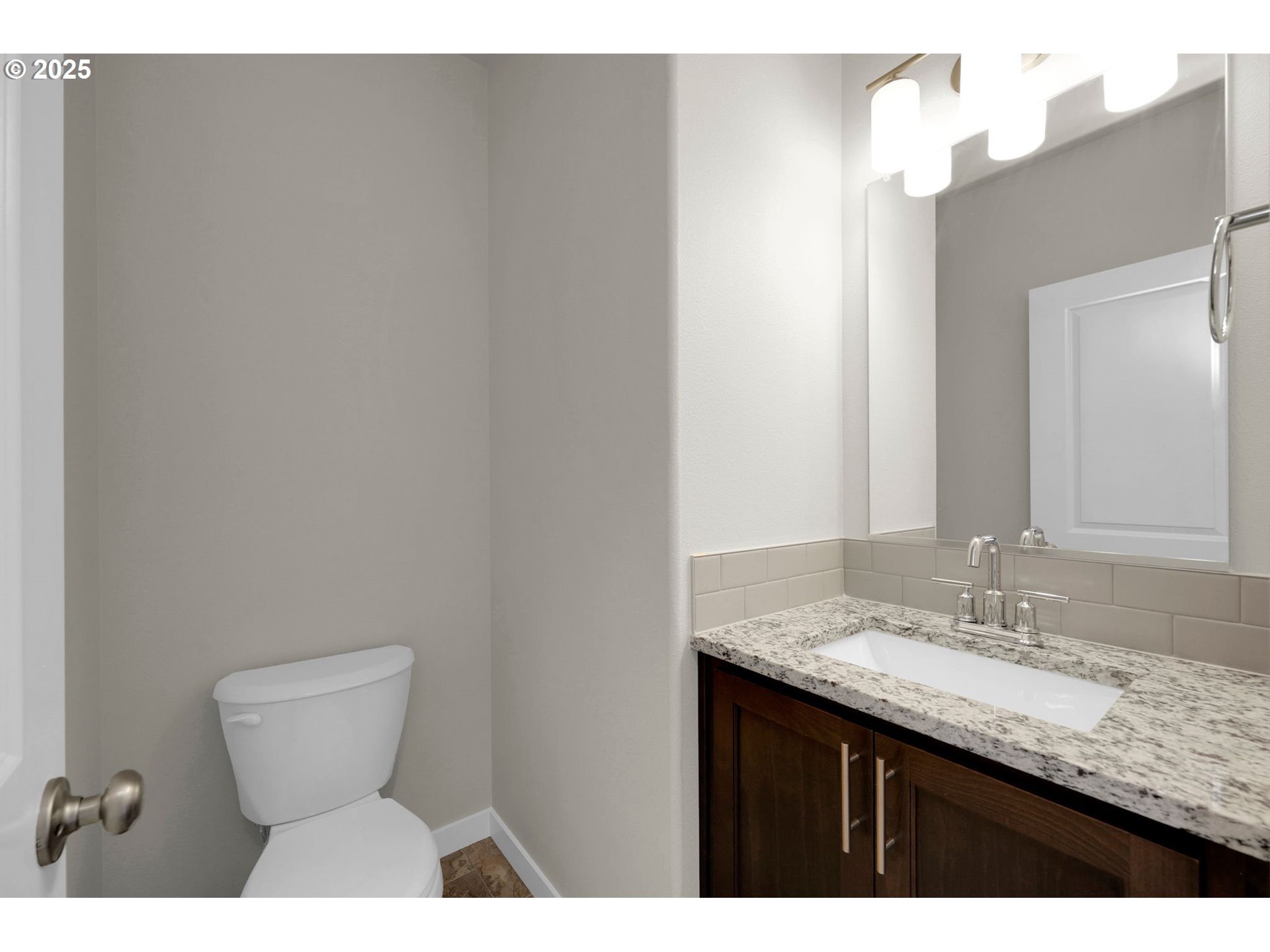 5679 Magnificence Way Eugene, OR 97402 - Photo 8 of 45 a bathroom with a granite countertop sink a toilet and a mirror