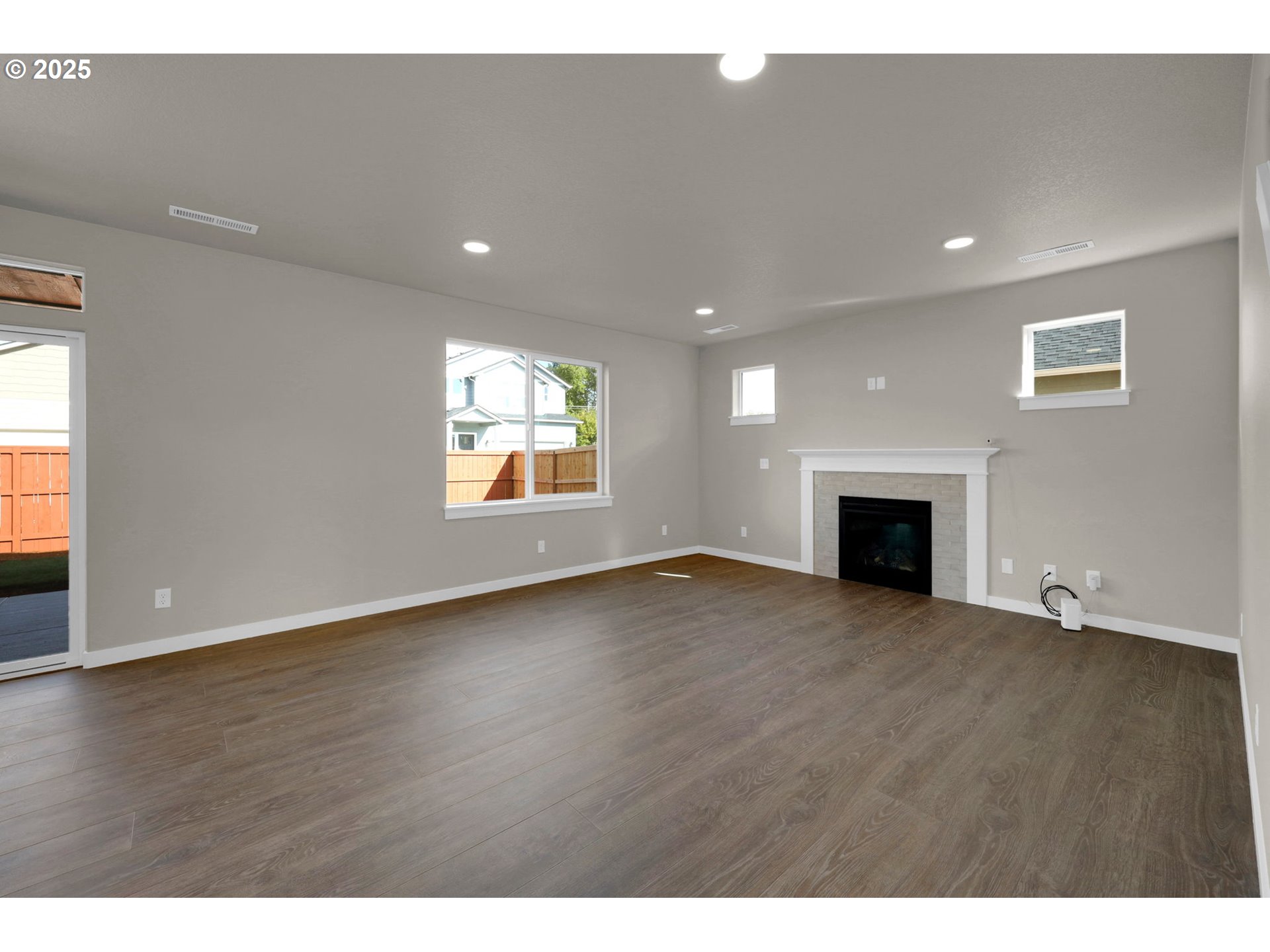 5679 Magnificence Way Eugene, OR 97402 - Photo 9 of 45 a view of empty room with wooden floor and fireplace