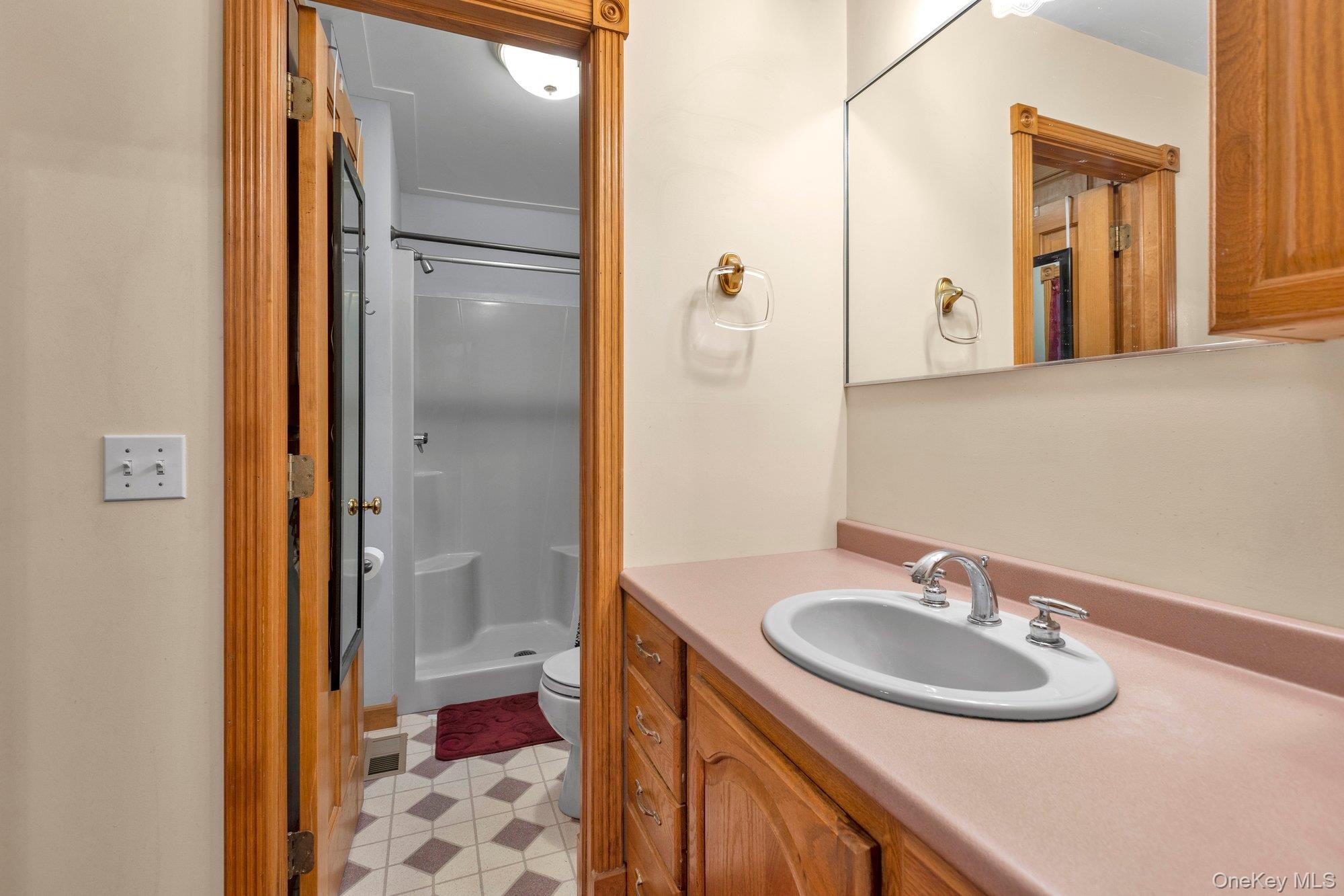 501 Wading River Road Manorville, NY 11949 - Photo 12 of 31 Full bath featuring a shower stall and vanity