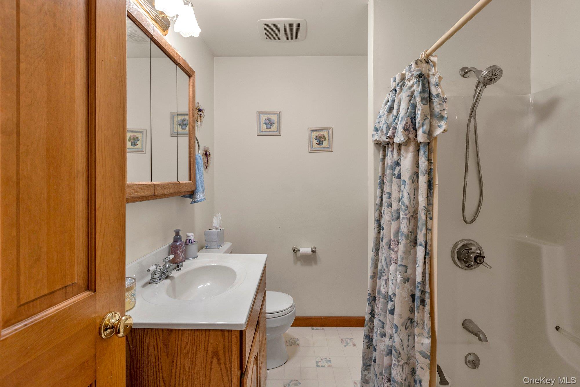 501 Wading River Road Manorville, NY 11949 - Photo 16 of 31 Full bath with shower / tub combo with curtain and vanity