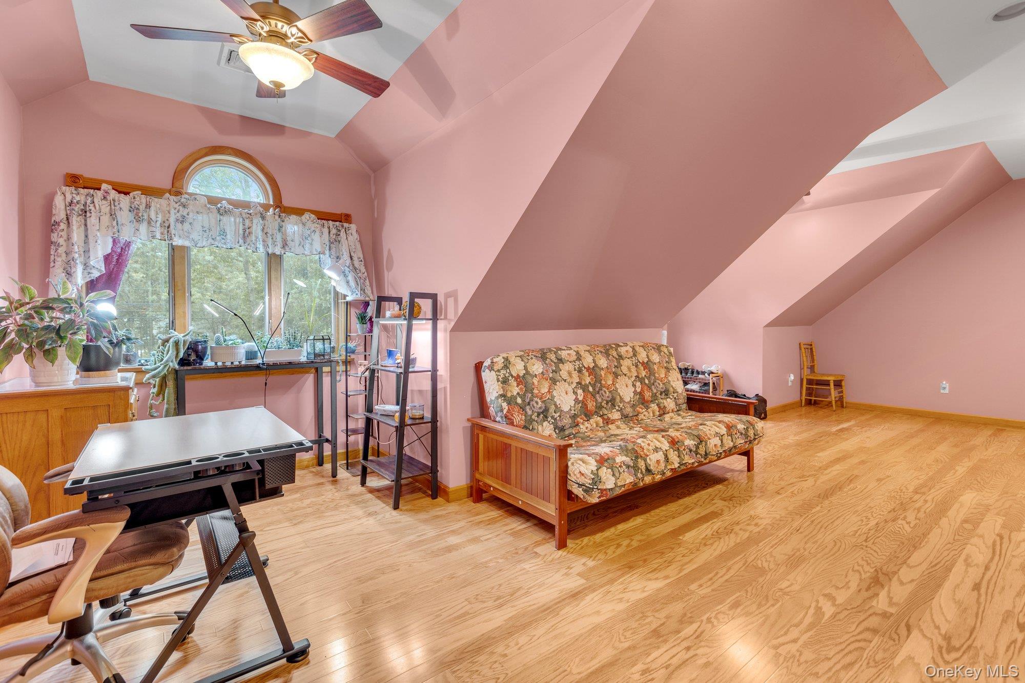 501 Wading River Road Manorville, NY 11949 - Photo 18 of 31 Living area featuring lofted ceiling, light wood-type flooring, and a ceiling fan