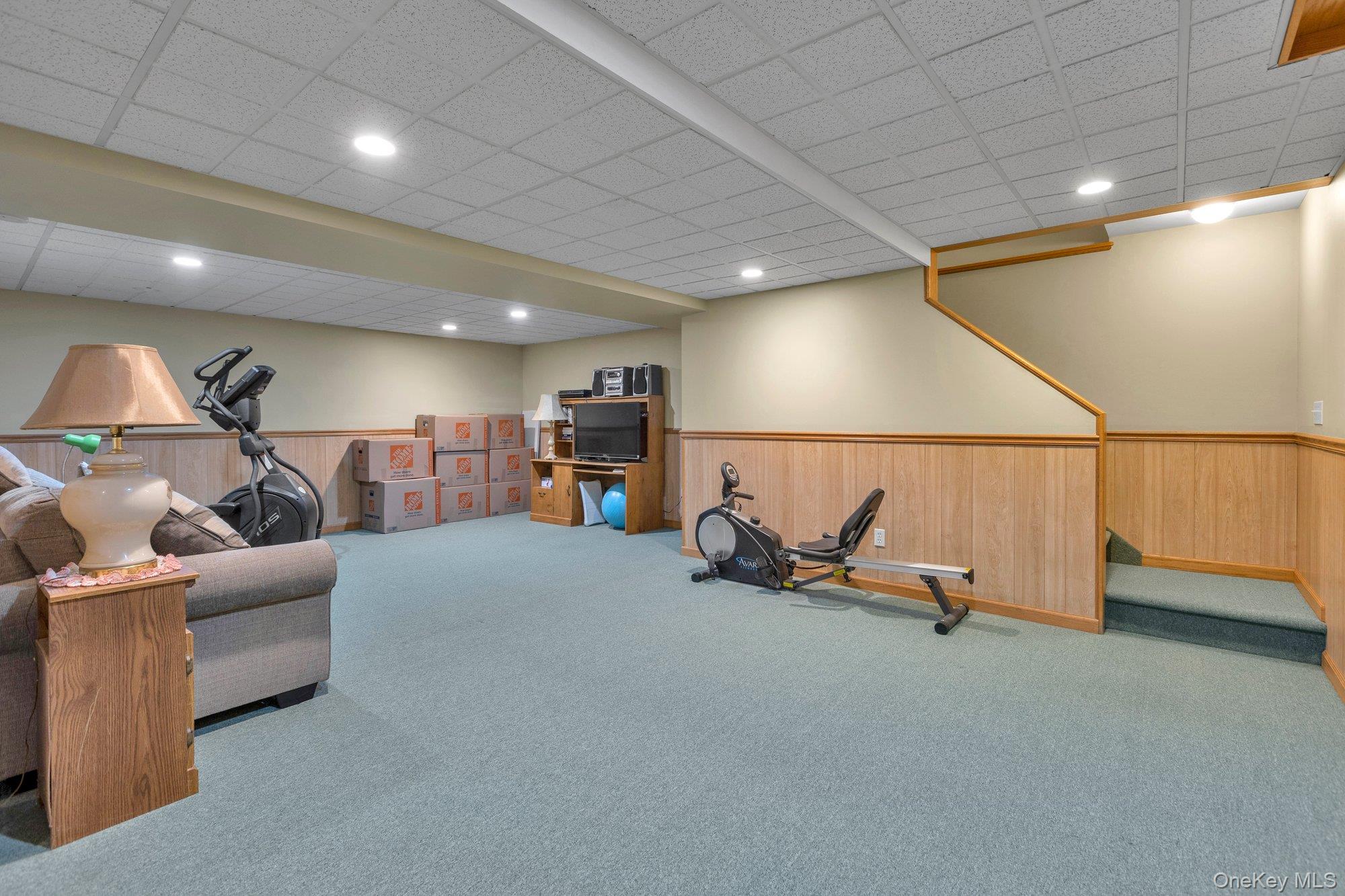 501 Wading River Road Manorville, NY 11949 - Photo 26 of 31 Exercise room featuring a wainscoted wall, carpet, wood walls, a drop ceiling, and recessed lighting