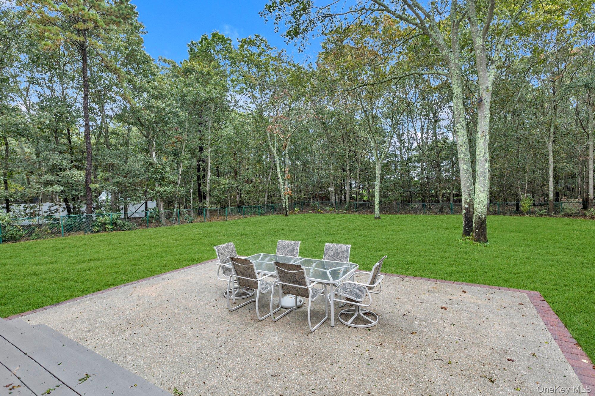 501 Wading River Road Manorville, NY 11949 - Photo 30 of 31 Fenced backyard featuring a patio area and outdoor dining space