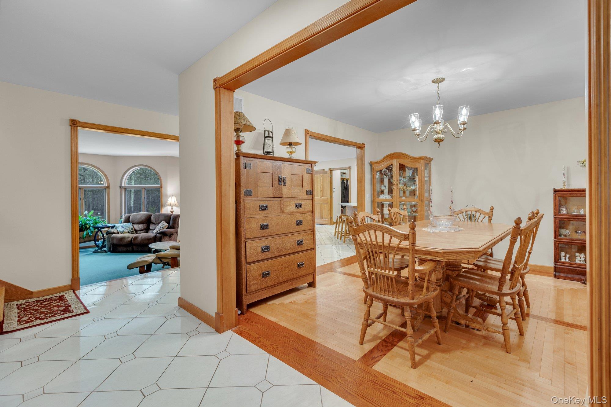 501 Wading River Road Manorville, NY 11949 - Photo 3 of 31 Dining space with light wood-style floors and a chandelier