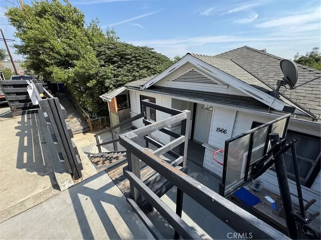 a view of a roof deck with chair and wooden floor