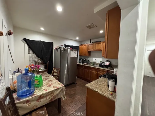 a kitchen with stainless steel appliances granite countertop sink refrigerator and microwave