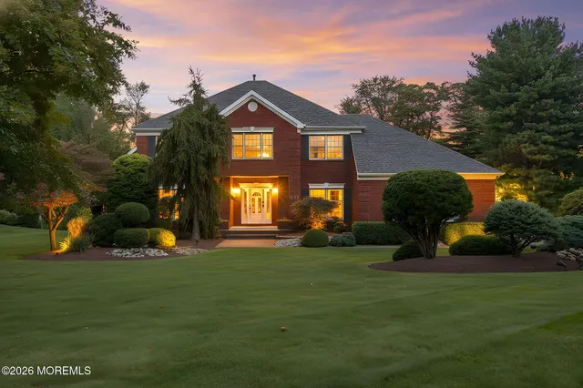 a front view of a house with a garden