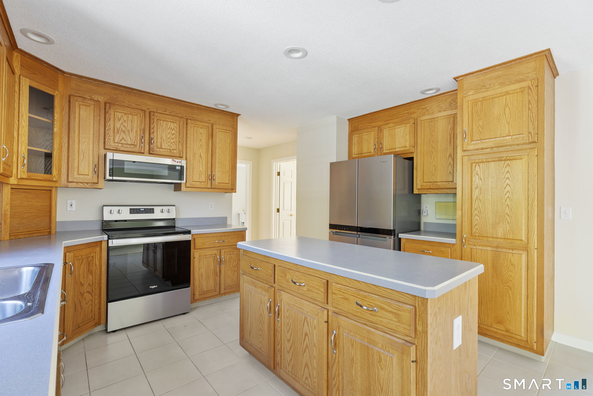 555 Waterville Road Avon, CT 06001 - Photo 24 of 40 a kitchen with stainless steel appliances granite countertop a stove a sink and a microwave
