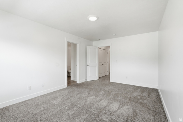 1173 West 1870 South Logan, UT 84321 - Photo 11 of 33 Spacious interior room featuring light gray carpeting, white walls, and bright overhead lighting