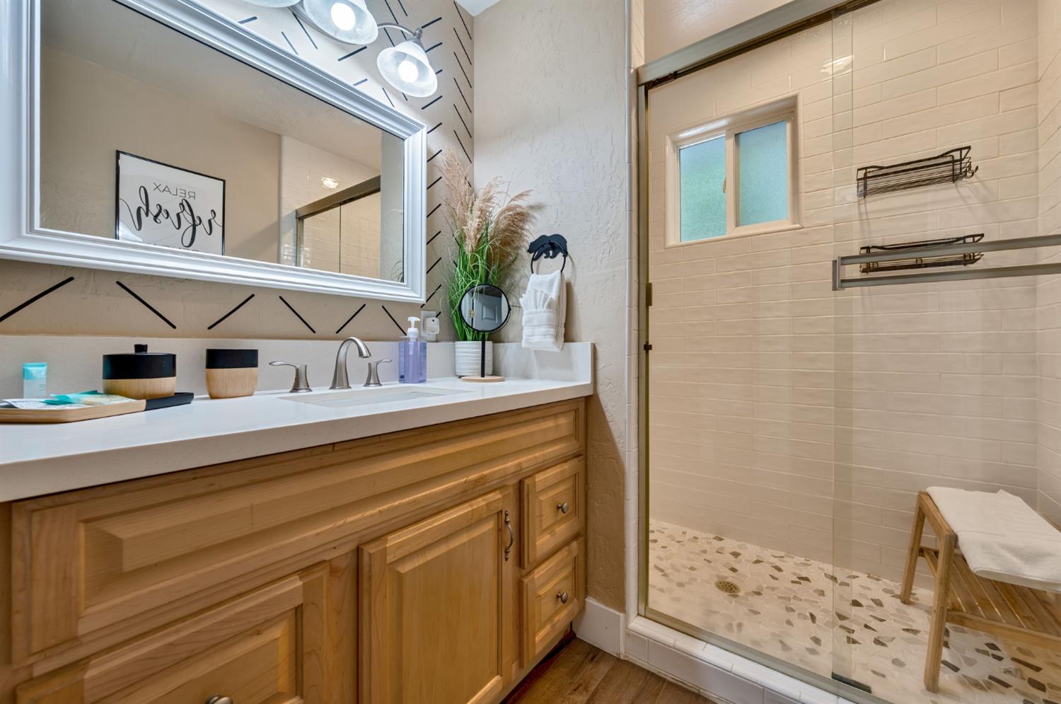 3960 Garnet Road Pollock Pines, CA 95726 - Photo 23 of 50 a bathroom with a sink a mirror and a shower