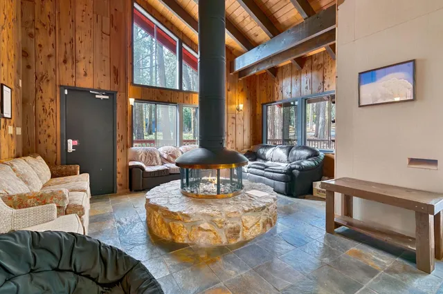 a living room with furniture and floor to ceiling windows