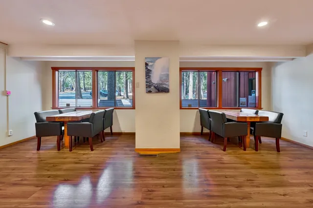 a view of a dining room with furniture window and wooden floor
