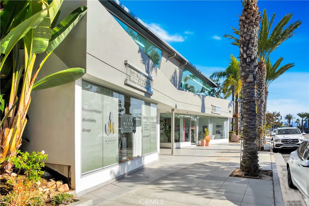 24691 Del Prado Avenue Dana Point, CA 92629 - Photo 11 of 67 a view of a building with a trees in front of it