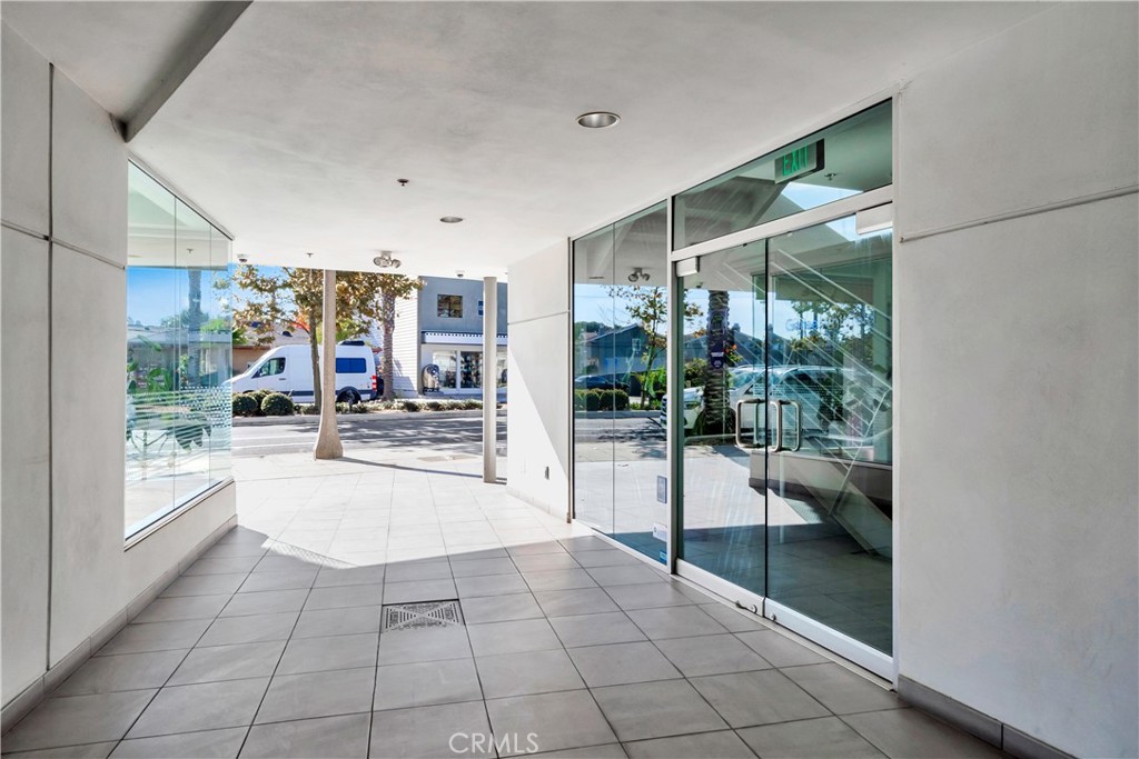 24691 Del Prado Avenue Dana Point, CA 92629 - Photo 20 of 67 a hallway with a glass door and shower