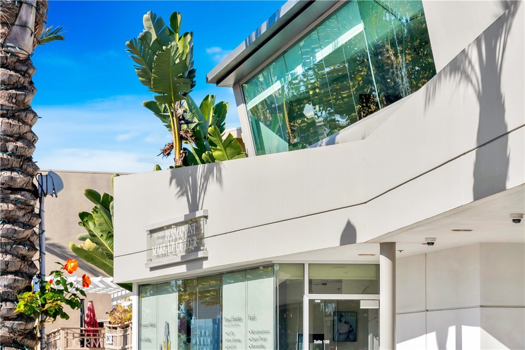 24691 Del Prado Avenue Dana Point, CA 92629 - Photo 2 of 67 a vase of flowers sitting on a floor with a glass door
