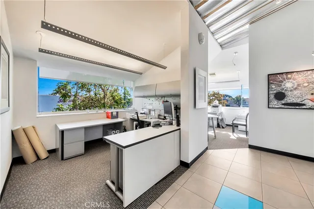 a kitchen with stainless steel appliances a stove a refrigerator and white cabinets