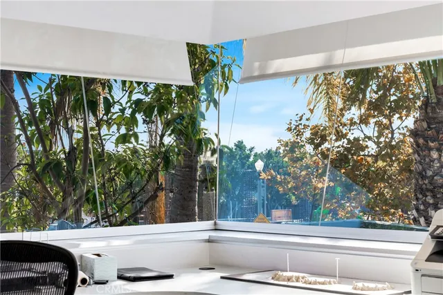 a living room with furniture a flat screen tv and a floor to ceiling window