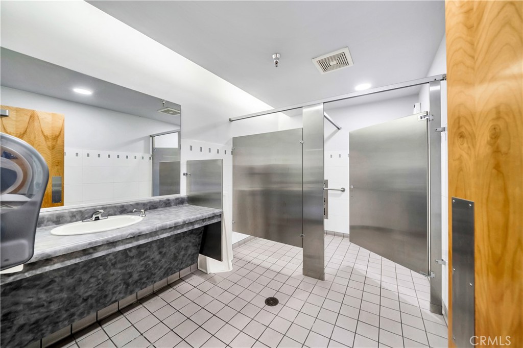 24691 Del Prado Avenue Dana Point, CA 92629 - Photo 55 of 67 a bathroom with a double vanity sink mirror and shower