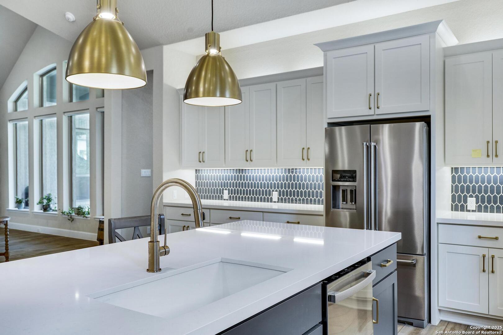 10027 Sarah Place Boerne, TX 78006 - Photo 11 of 47 a kitchen with stainless steel appliances a sink a table and chairs