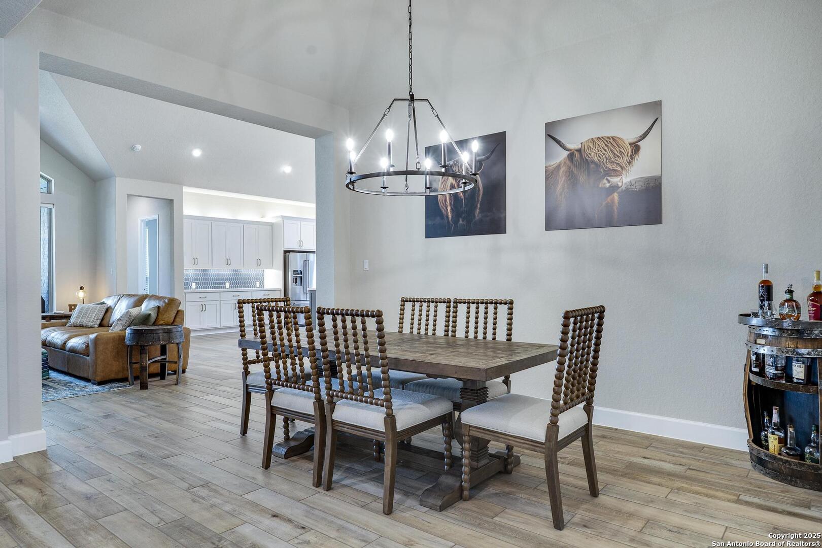 10027 Sarah Place Boerne, TX 78006 - Photo 13 of 47 a view of a dining room with furniture wooden floor and a chandelier