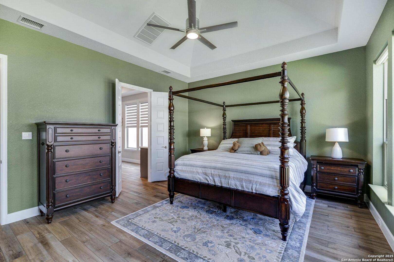 10027 Sarah Place Boerne, TX 78006 - Photo 19 of 47 a bedroom with a bed and a walk in closet