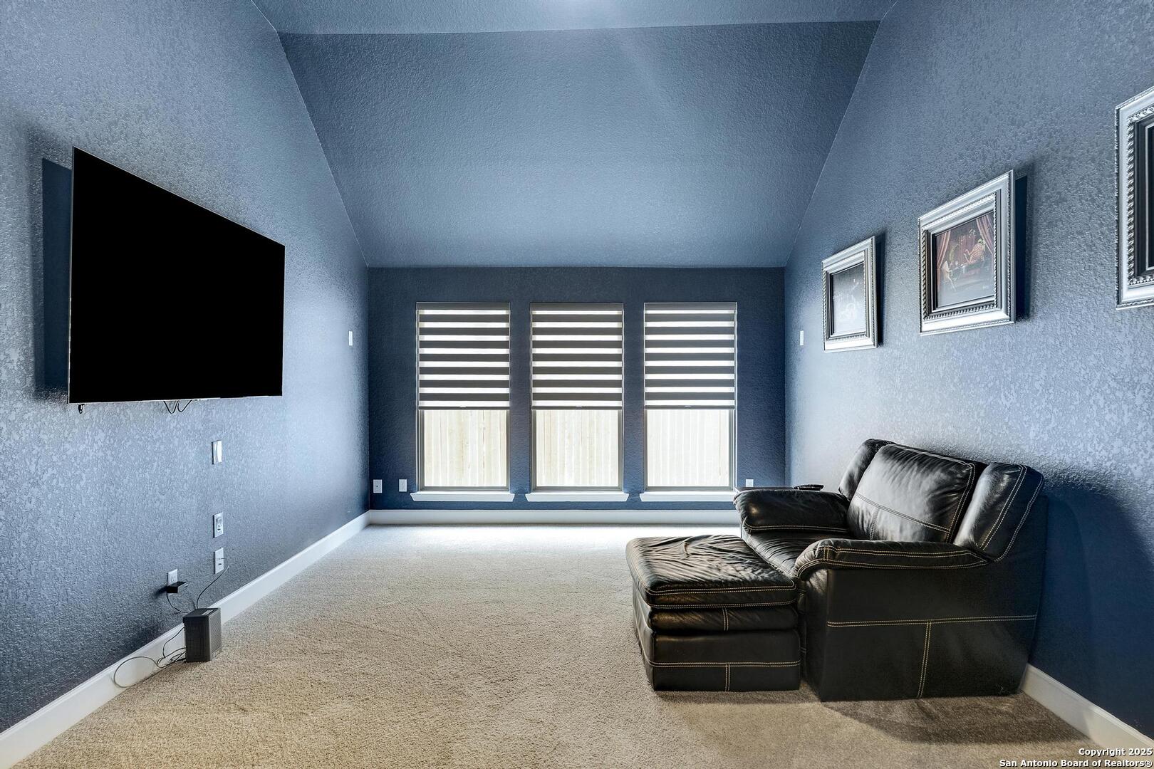 10027 Sarah Place Boerne, TX 78006 - Photo 24 of 47 a living room with furniture and a flat screen tv