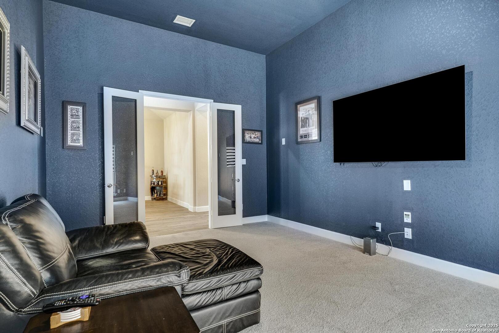 10027 Sarah Place Boerne, TX 78006 - Photo 25 of 47 a living room with furniture and a flat screen tv