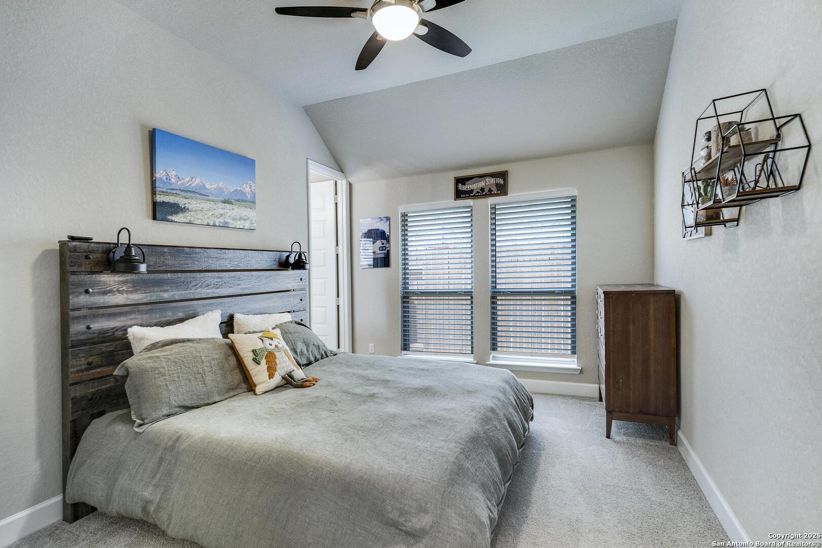 10027 Sarah Place Boerne, TX 78006 - Photo 28 of 47 a bedroom with a bed and ceiling fan