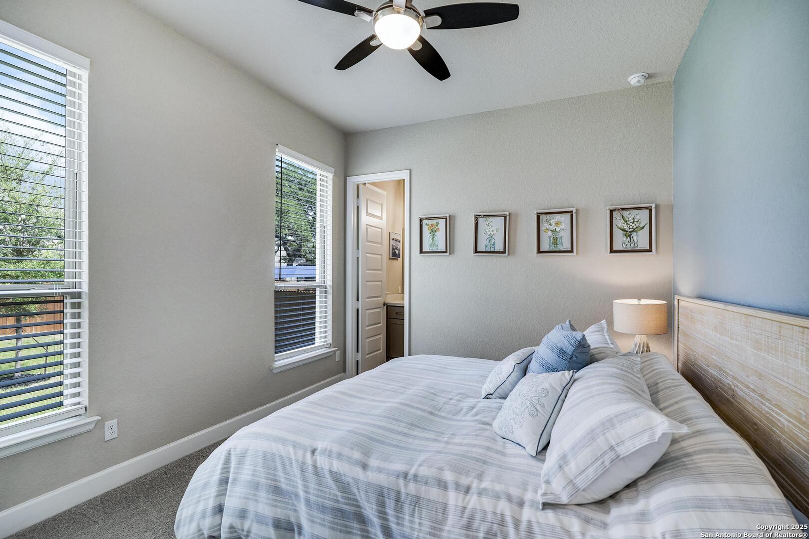 10027 Sarah Place Boerne, TX 78006 - Photo 30 of 47 a bedroom with a large bed and a window