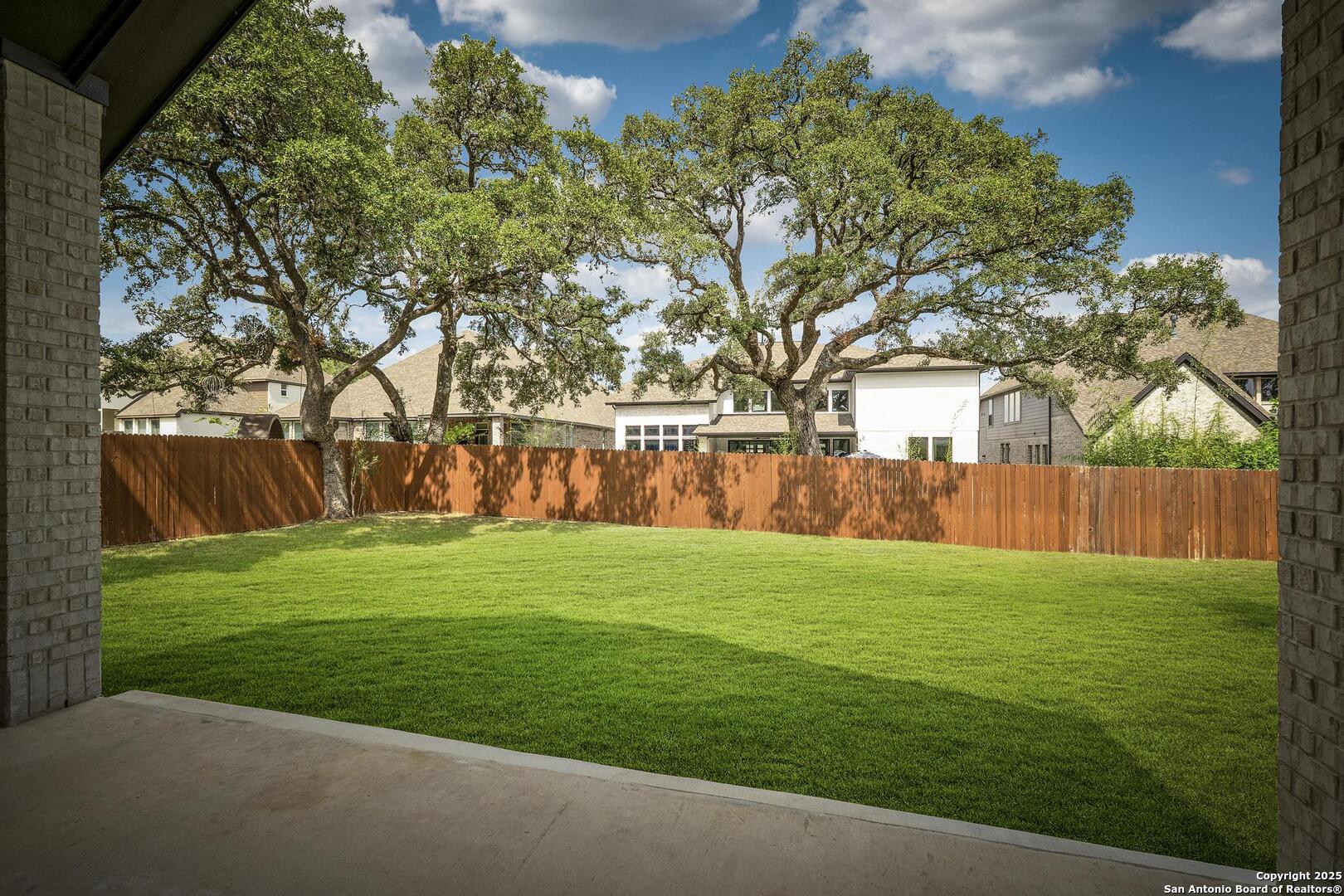 10027 Sarah Place Boerne, TX 78006 - Photo 34 of 47 a view of a backyard with large trees