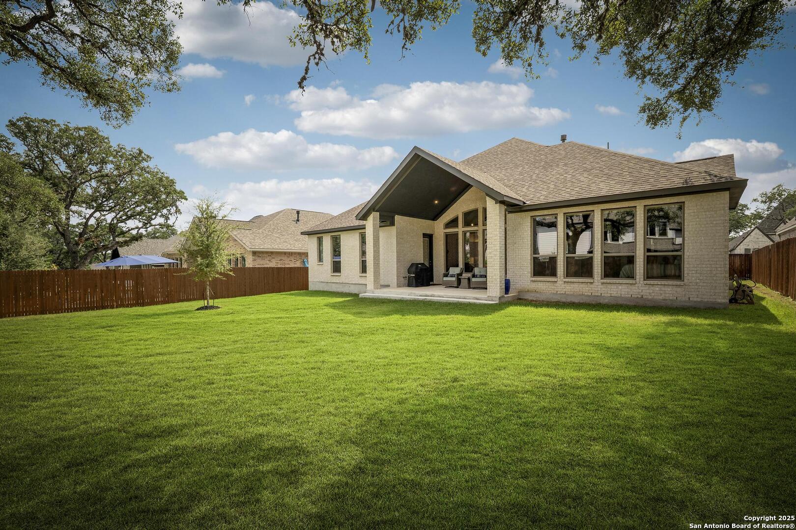 10027 Sarah Place Boerne, TX 78006 - Photo 36 of 47 a view of a house with a backyard