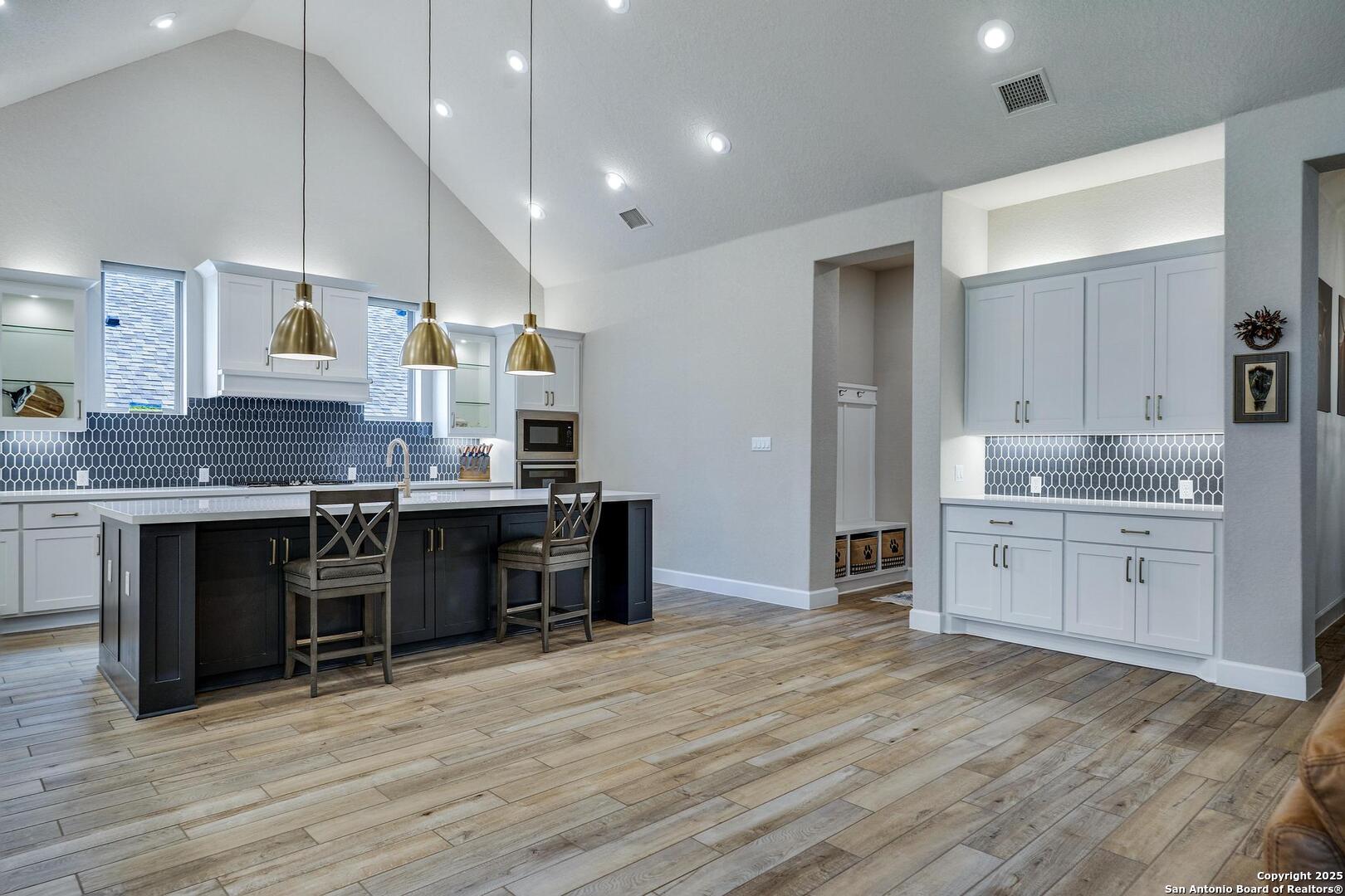 10027 Sarah Place Boerne, TX 78006 - Photo 7 of 47 a large kitchen with stainless steel appliances granite countertop a stove and cabinets