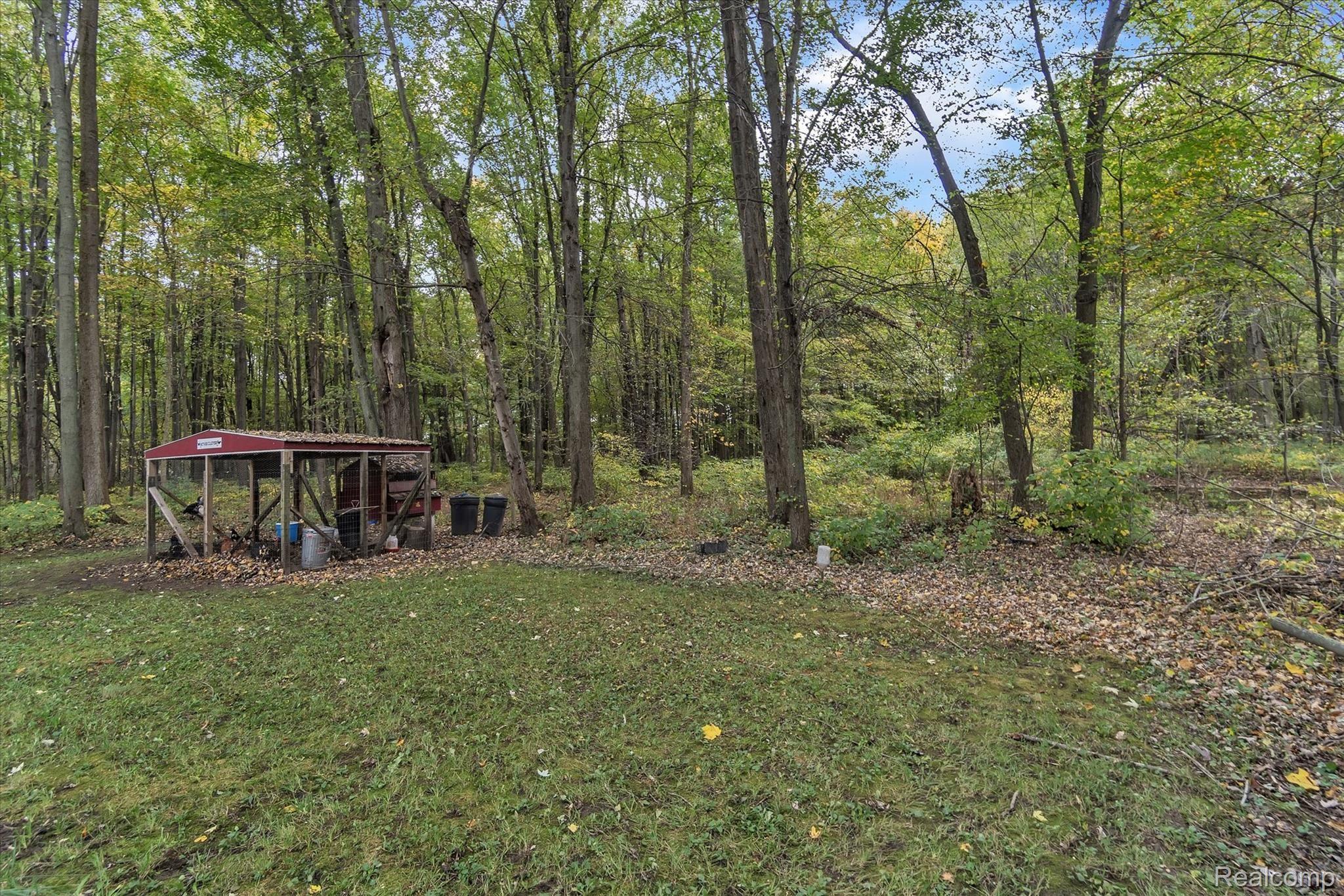 5190 South Bull Run Road Gregory, MI 48137 - Photo 32 of 38 Chicken Coop and Back Woods