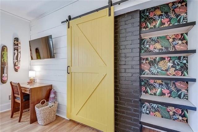 3353 Myrtle Street Hapeville, GA 30354 - Photo 12 of 22 a view of a hallway with wooden floor and a painting on the wall