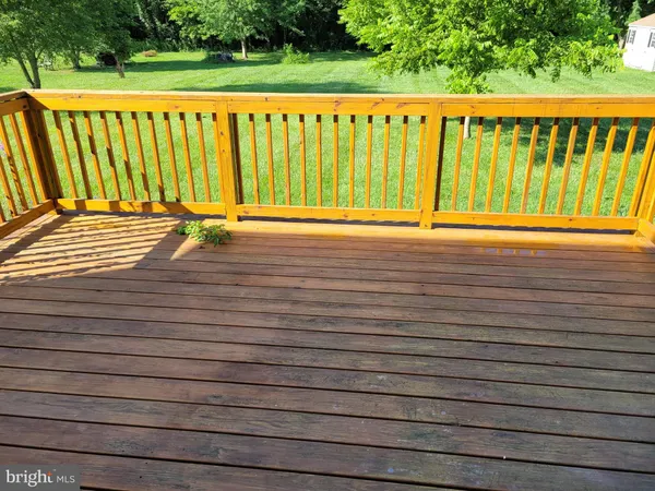 a view of a balcony with wooden floor