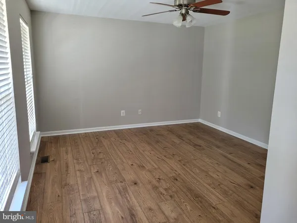 a view of a room with wooden floor and a window