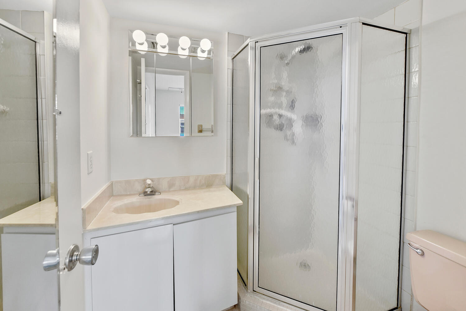 2871 North Ocean Boulevard, Unit F429 Boca Raton, FL 33431 - Photo 17 of 38 a bathroom with a sink a mirror a vanity and a shower