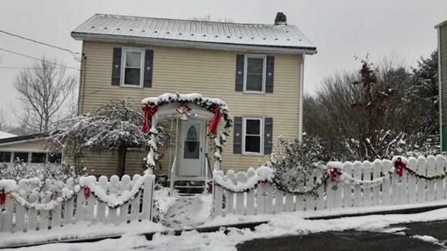 a front view of a house with outdoor seating