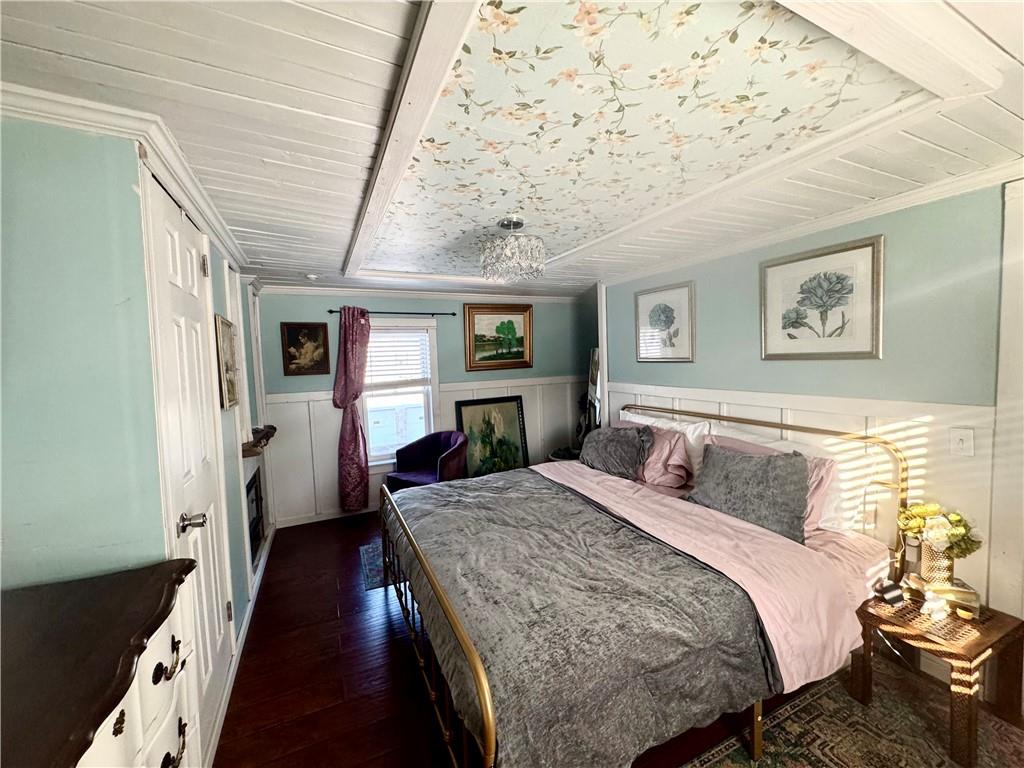 110 Boquet Street Ligonier, PA 15658 - Photo 12 of 16 a bed room with a bed and a chandelier