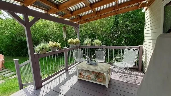 a view of roof deck with wooden floor and fence