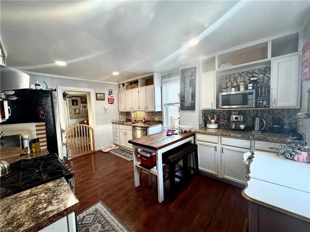 110 Boquet Street Ligonier, PA 15658 - Photo 7 of 16 a kitchen with stainless steel appliances granite countertop a stove refrigerator and cabinets