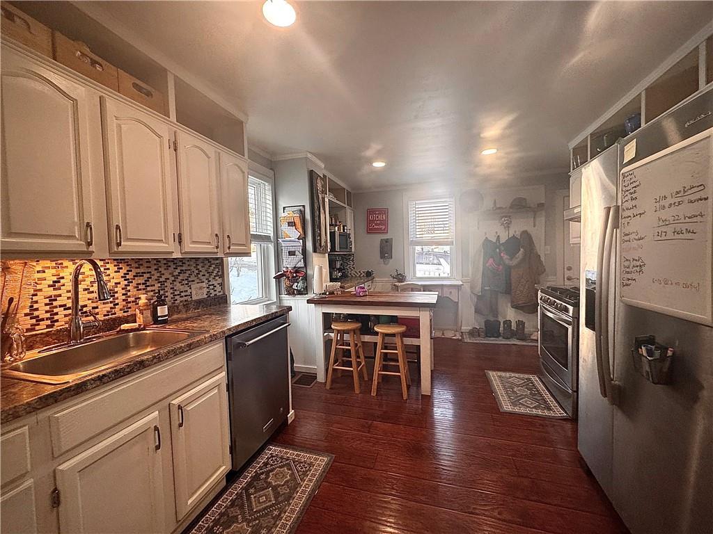 110 Boquet Street Ligonier, PA 15658 - Photo 8 of 16 a kitchen with stainless steel appliances granite countertop a refrigerator a stove top oven a sink dishwasher and white cabinets with wooden floor