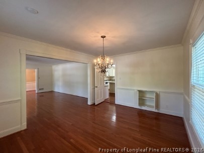 1513 Raeford Road Fayetteville, NC 28305 - Photo 5 of 25 an empty room with wooden floor and chandelier
