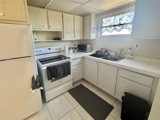 a kitchen with stainless steel appliances a stove a sink and a refrigerator
