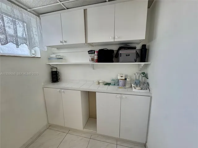 a kitchen with a cabinets and window