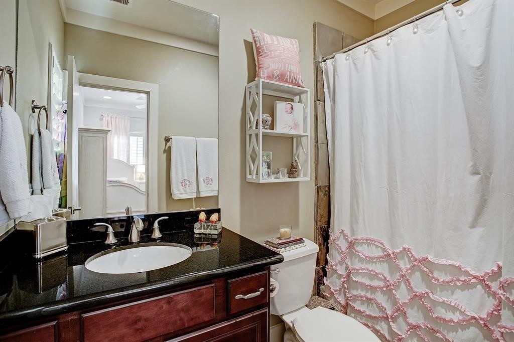 246 Detering Street Houston, TX 77007 - Photo 21 of 27 a bathroom with a sink and a mirror